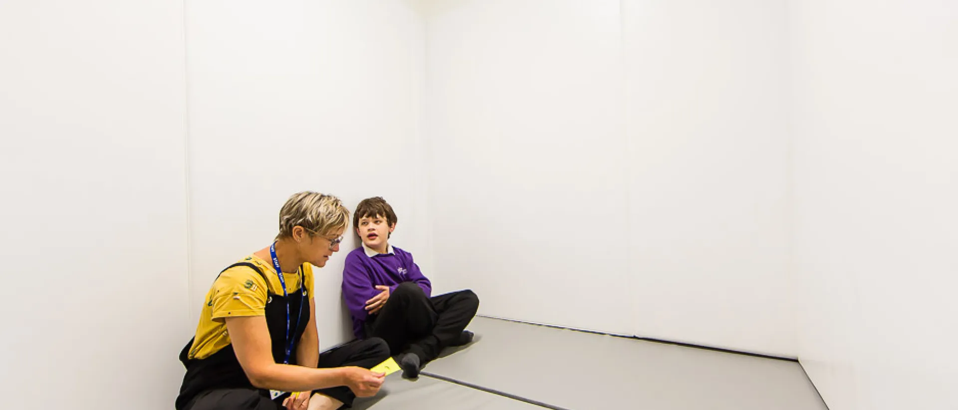 A student and teacher working together on developing skills.