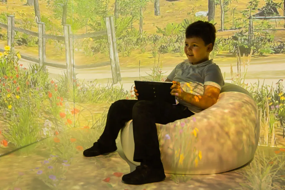 A child on a sensory bean bag.