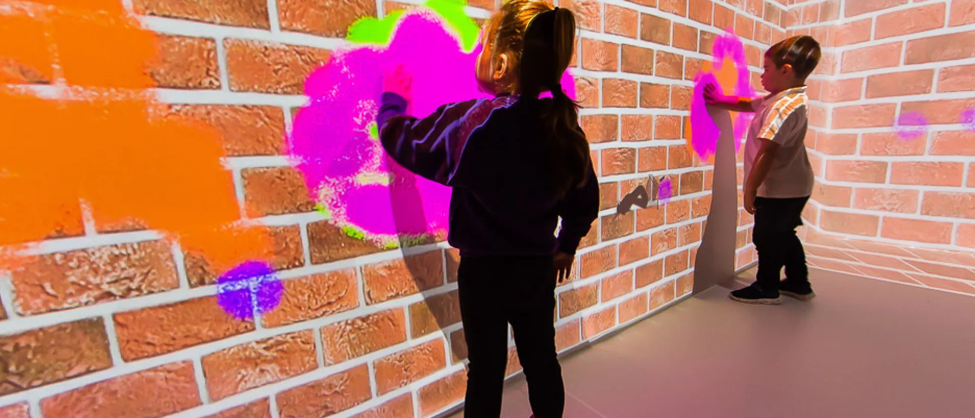 Two children engaging in immersive sensory play.