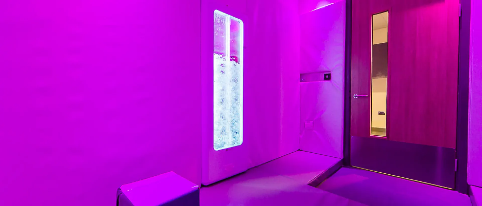 Pink projection light sensory room featuring an LED bubble tube.