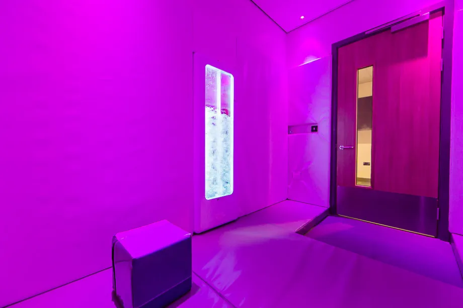 Pink projection light sensory room featuring an LED bubble tube.
