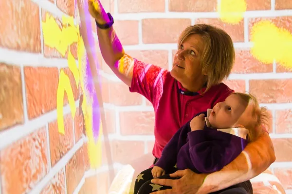 therapist using sensory room equipment during sensory session