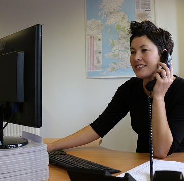 Woman on the phone giving out technical support advice
